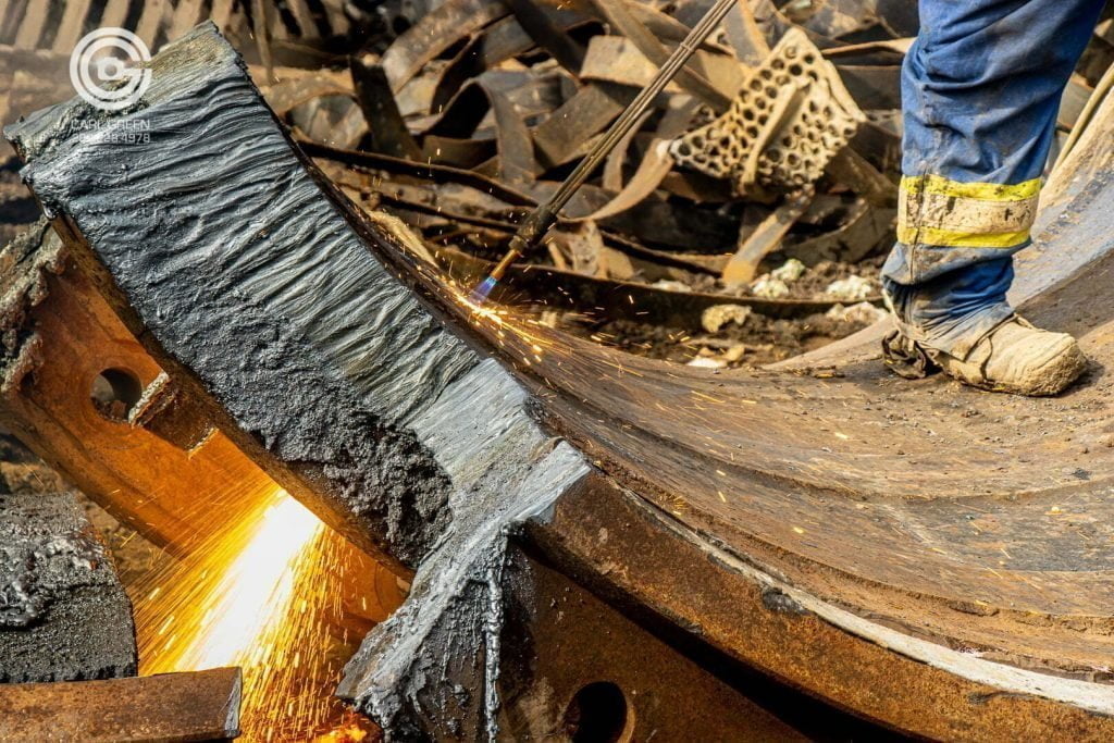 Cutting torch being used to cut up steel