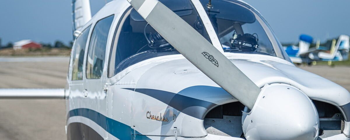 A small plane on the tarmac at an airport.