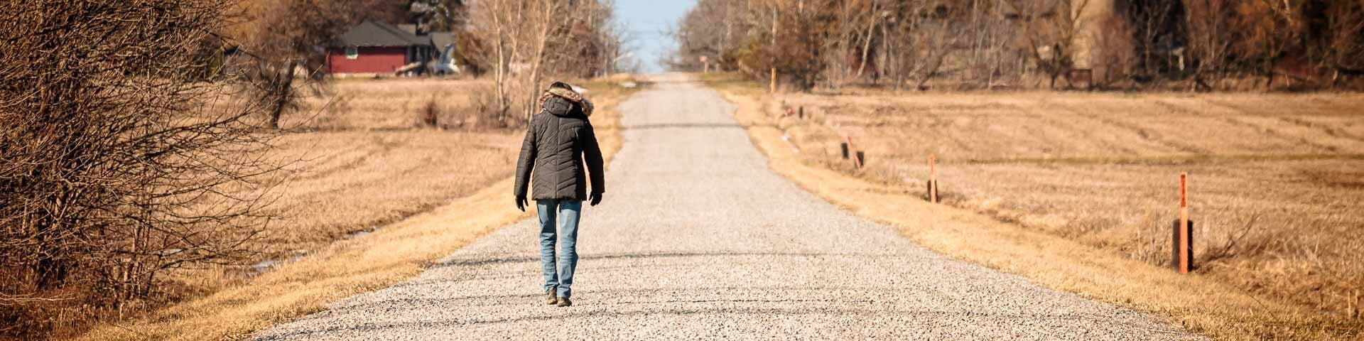 Woman walking on a gravel road in Port Colborne