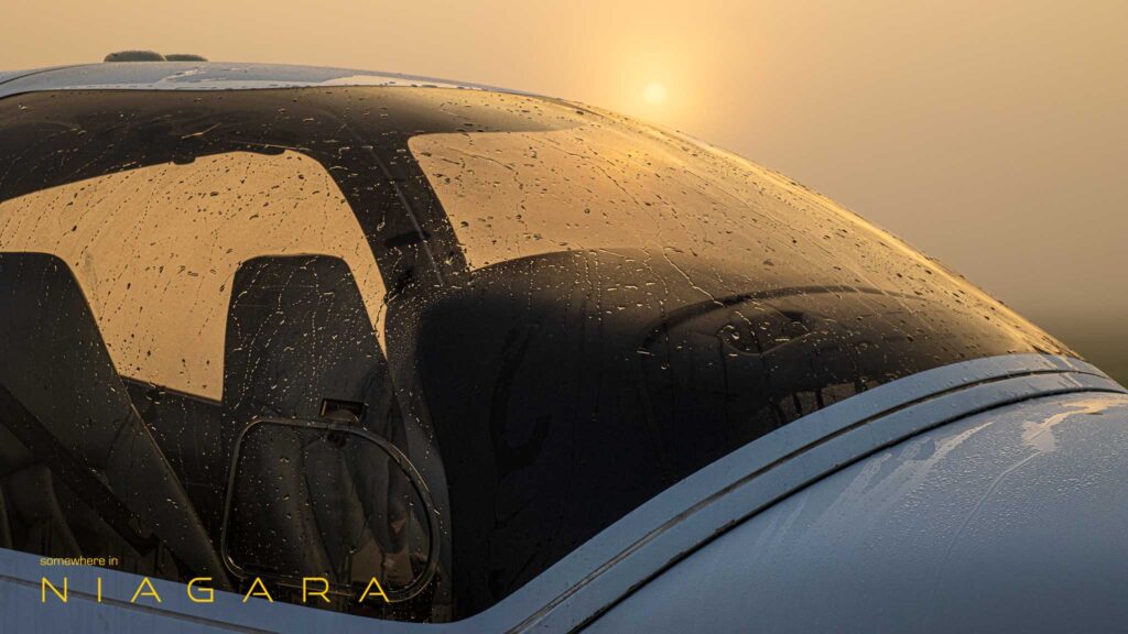 Airplane cockpit covered in early morning mist