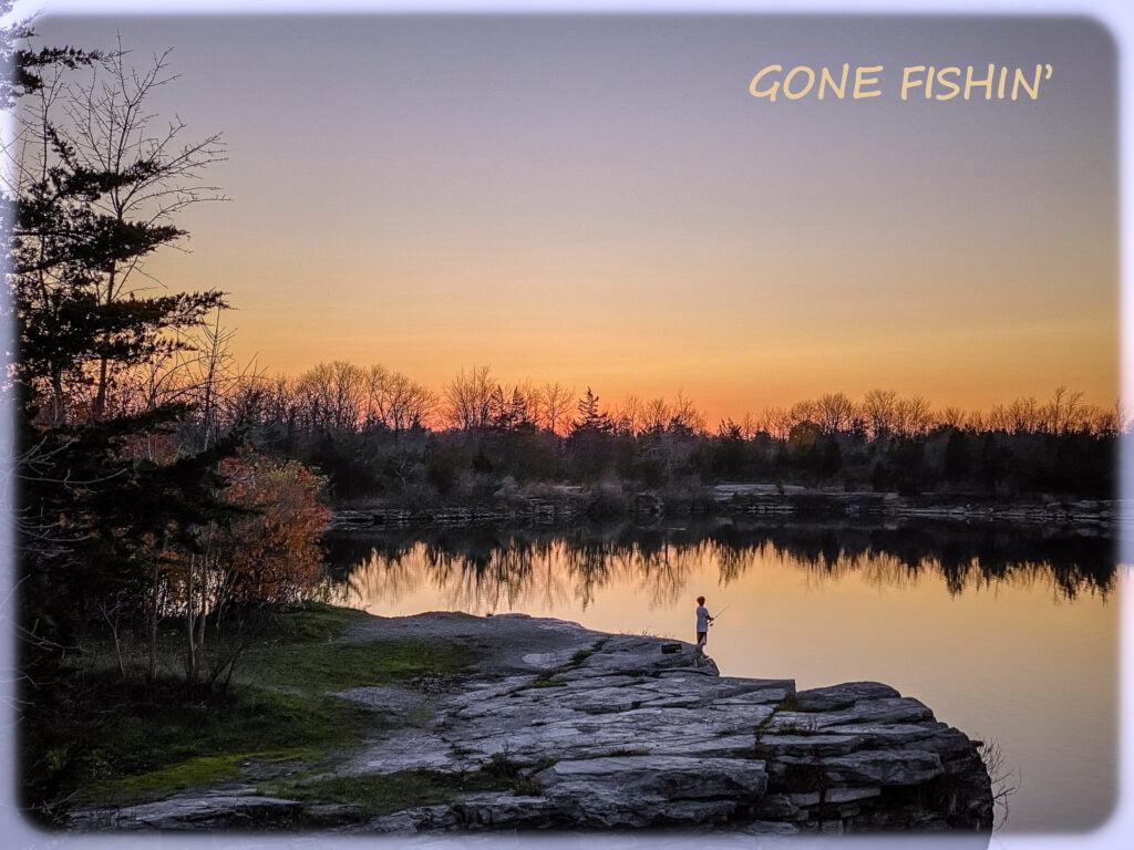 Boy fishing at sunset