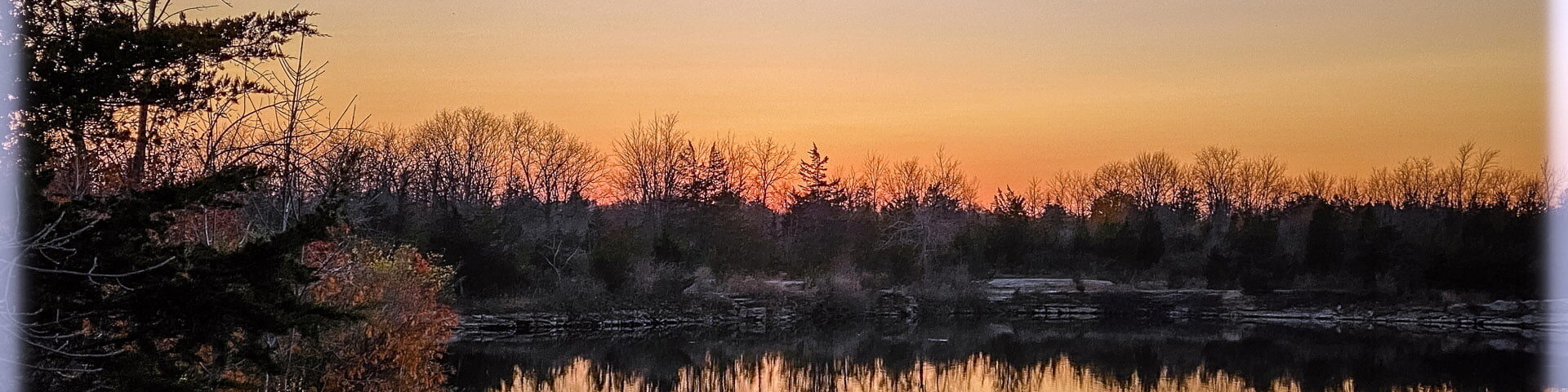 Boy fishing at sunset